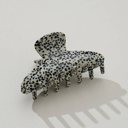beige claw clip with black speckled pattern
