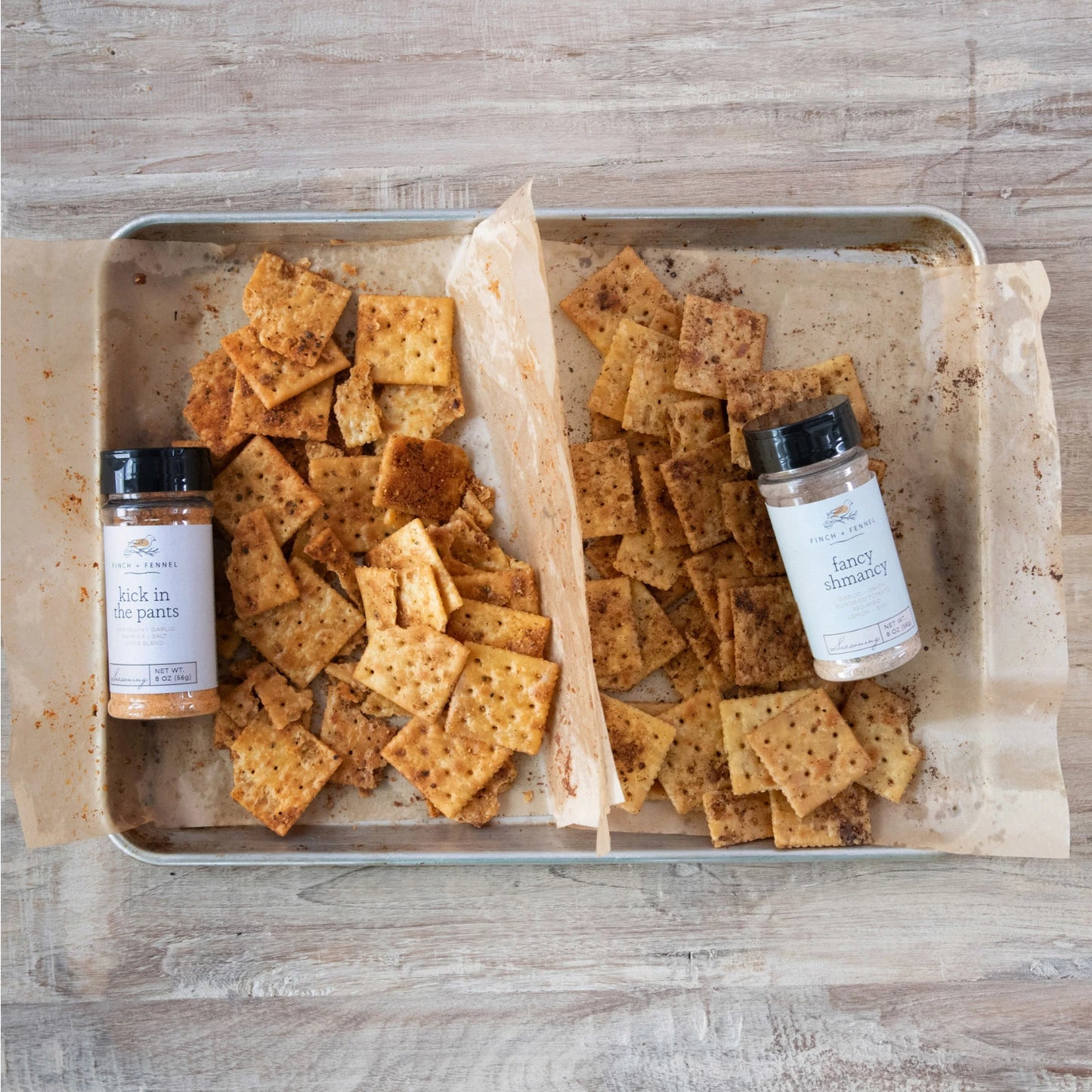 tray of seasoned crackers with bottles of seasoning.