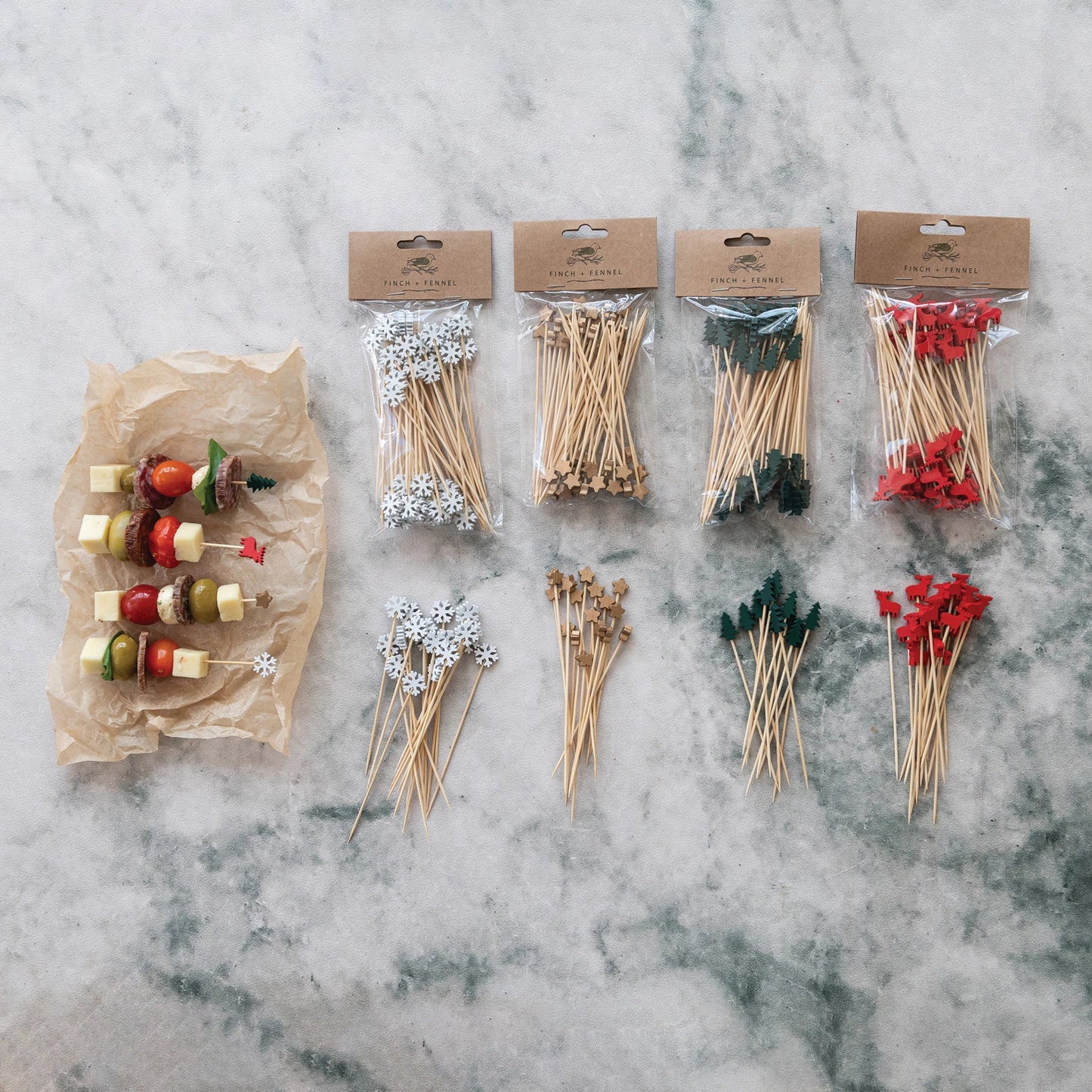assorted Bamboo Skewers with Holiday Topper arranged on a marble surface with kabobs next to them
