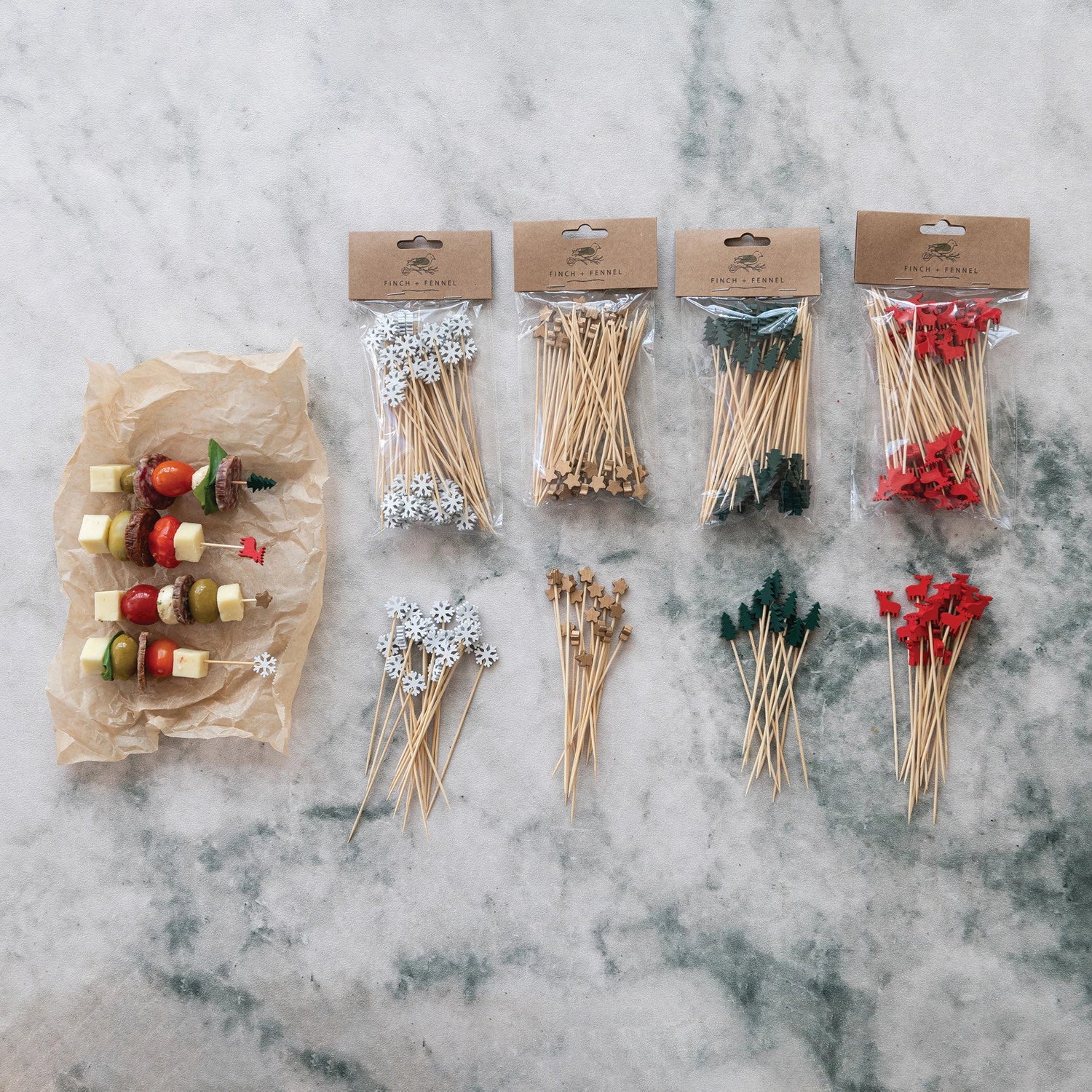 assorted Bamboo Skewers with Holiday Topper arranged on a marble surface with kabobs next to them
