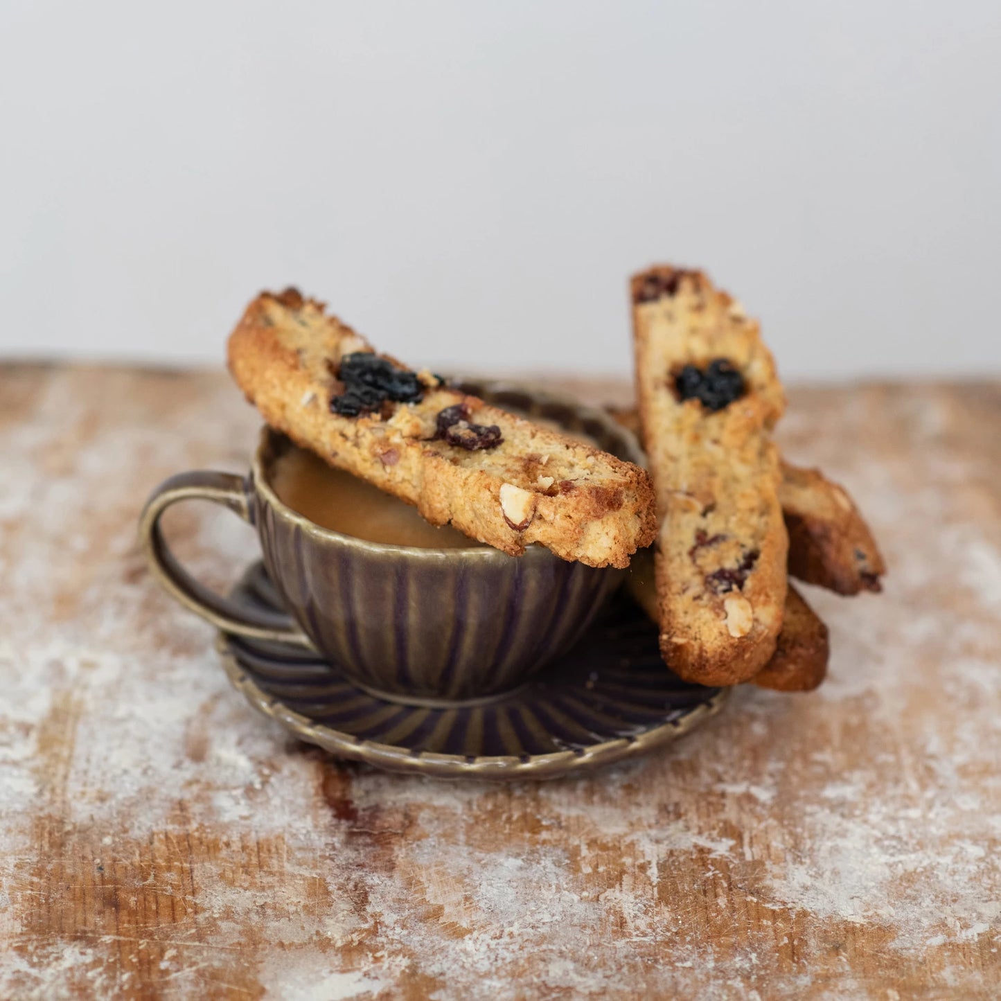 mug of coffee and 2 pieces of biscotti with Cherry Vanilla Fruit Preserves on them