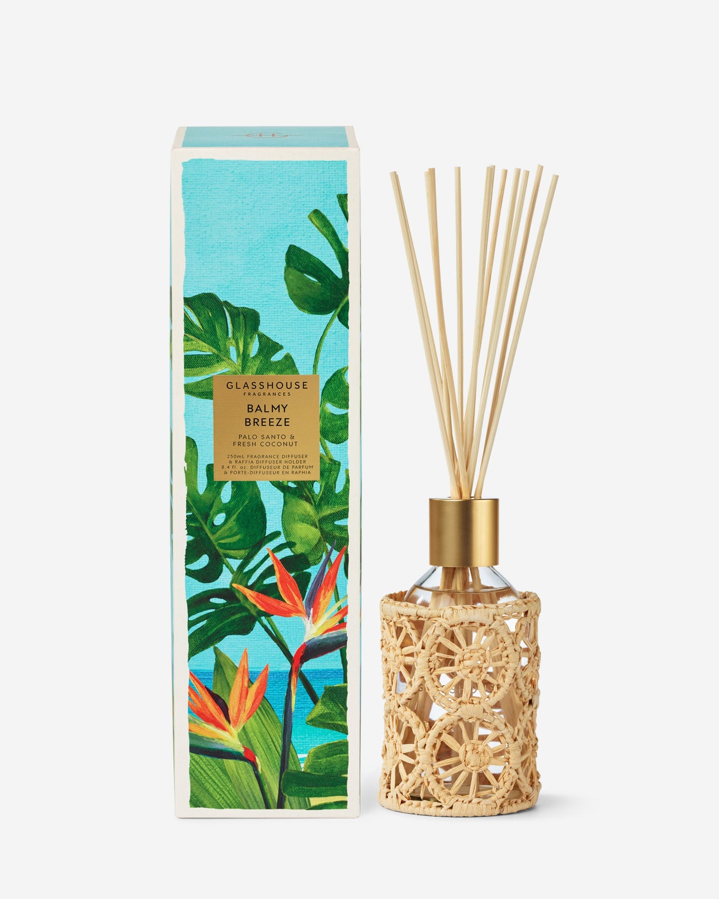 Diffuser with rattan design and decorative packaging featuring tropical plants on a white background
