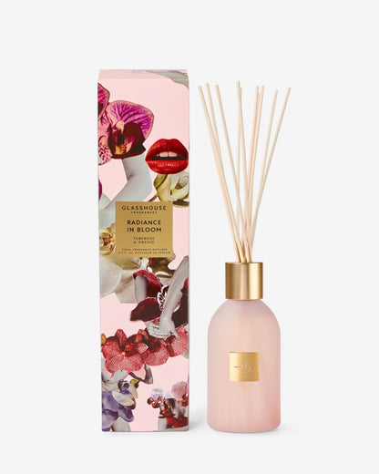 radiance in bloom fragrance diffuser next to its floral packaging