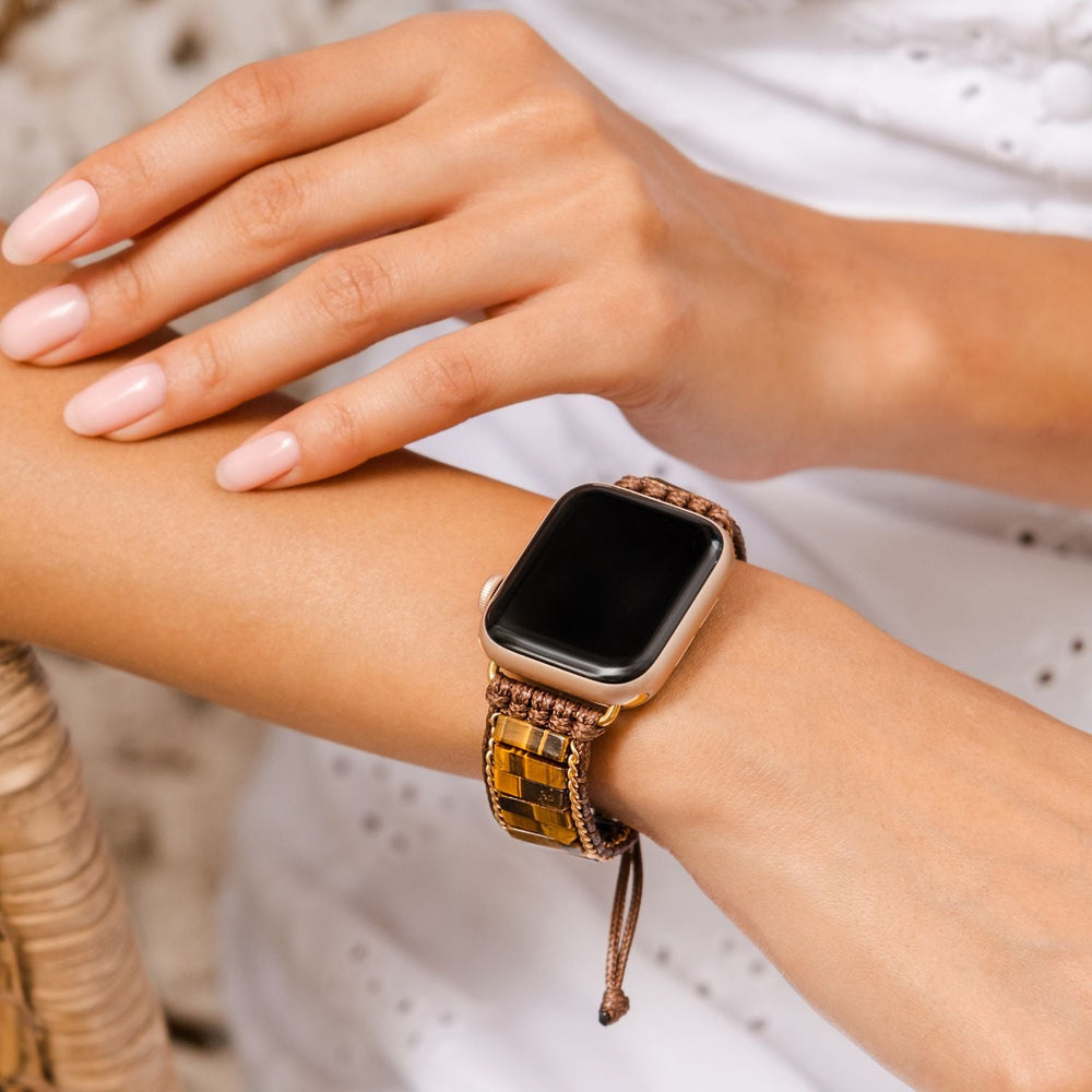 close-up of person's arm with fierce tiger's eye strap on an apple watch.