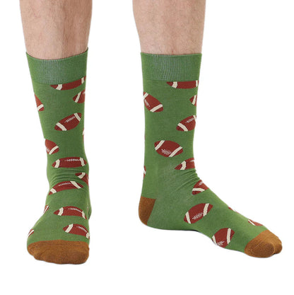 Green socks with football pattern worn by a person on a white background