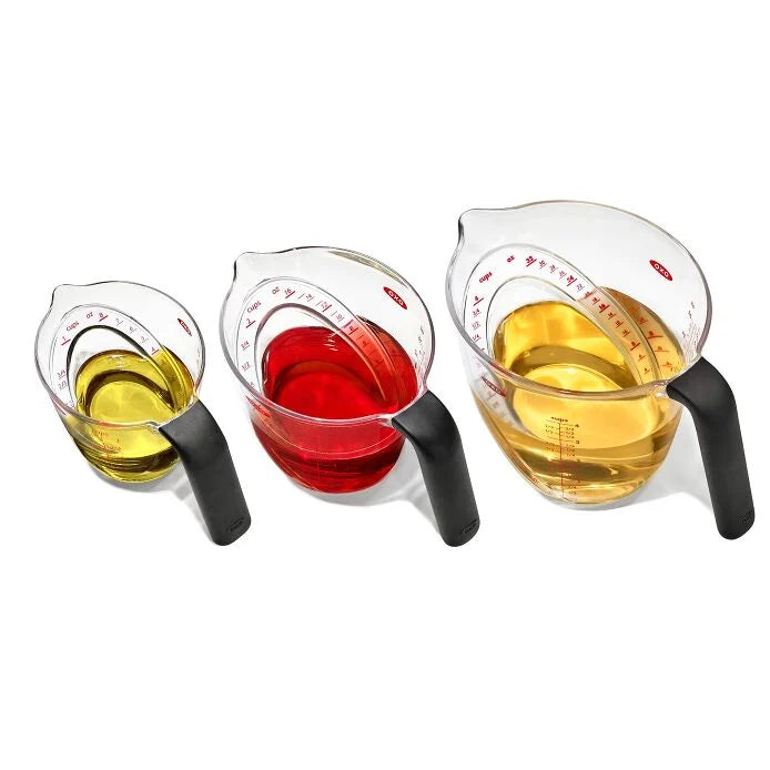 top view of Angled Measuring Cup Set filled with various liquids