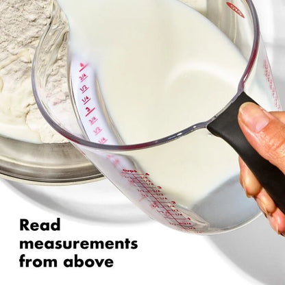 hand holding Angled Measuring Cup pouring batter ingredients into bowl