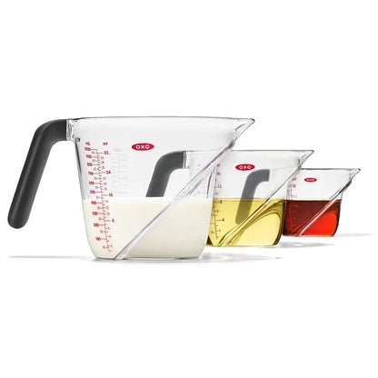 side view of Angled Measuring Cup Set filled with various liquids