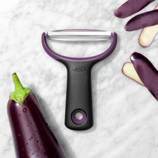 Good Grips Large Y-Peeler laying on a counter with eggplant