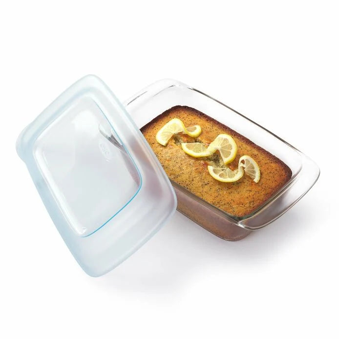 Glass Loaf Pan with lid set next to it and baked loaf in it