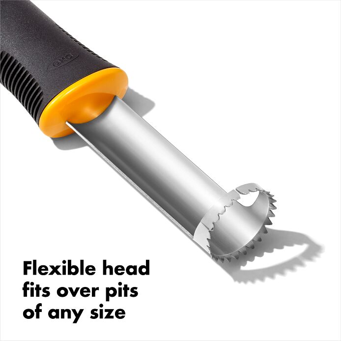 angled view of peach pitter on a white background