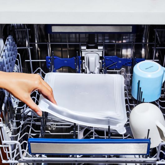 square Good Grips Silicone Bakeware Lid displayed in the top rack of a dishwasher