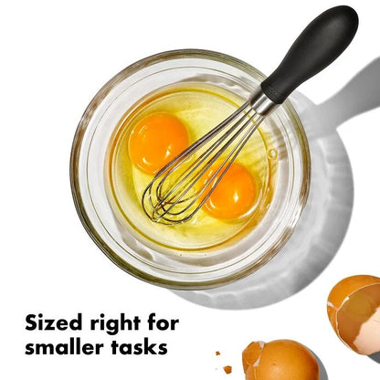 Mini Whisk in a glass bowl with unbeaten eggs 
