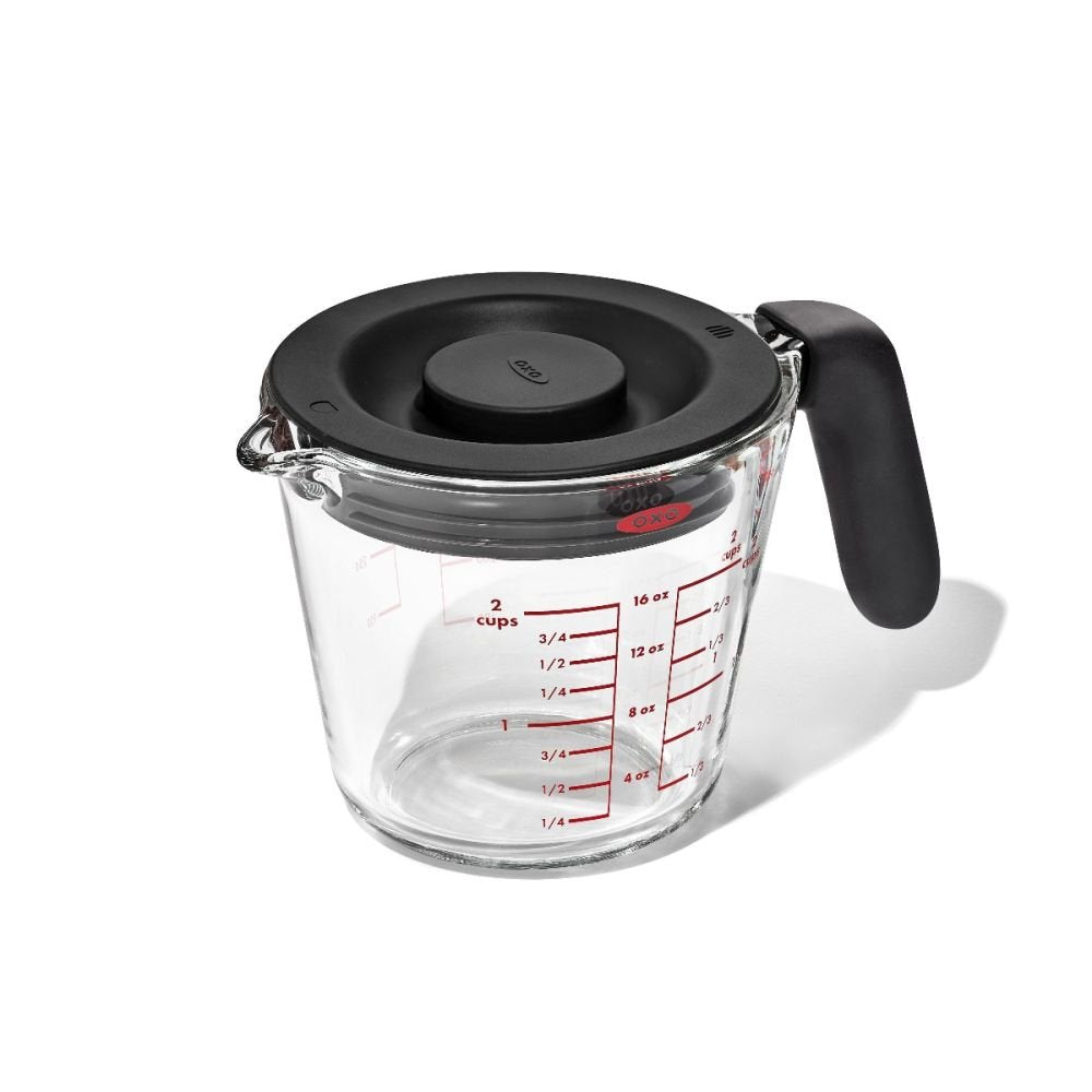 Glass Measuring cup with Lid with red measurement markings.