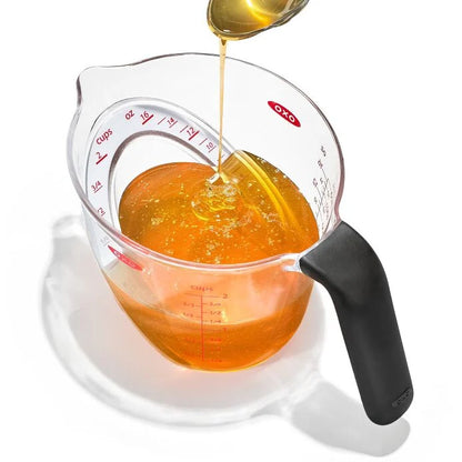 Angled Measuring Cup being filled with honey
