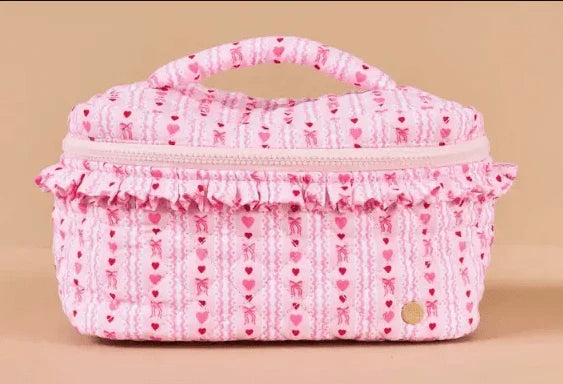 pink cosmetic case with red bow and heart design