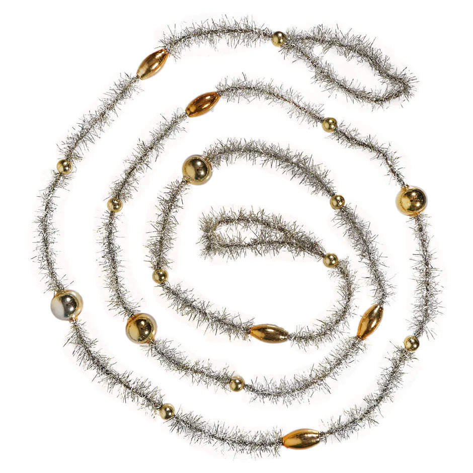 Decorative garland with gold beads and silver tinsel swirled on a white background