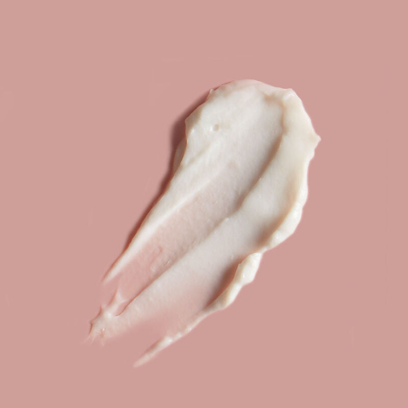 a smear of volcano hand cream on a pink background.