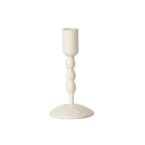white taper candle holder on a white background