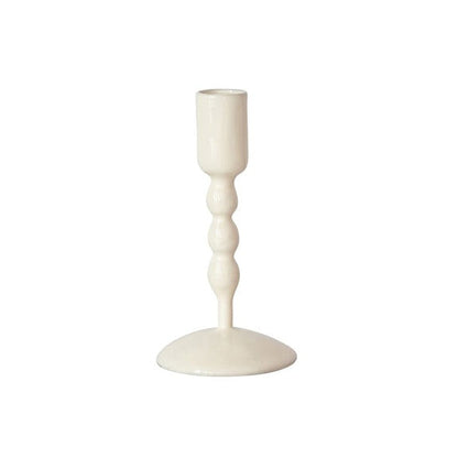 white taper candle holder on a white background