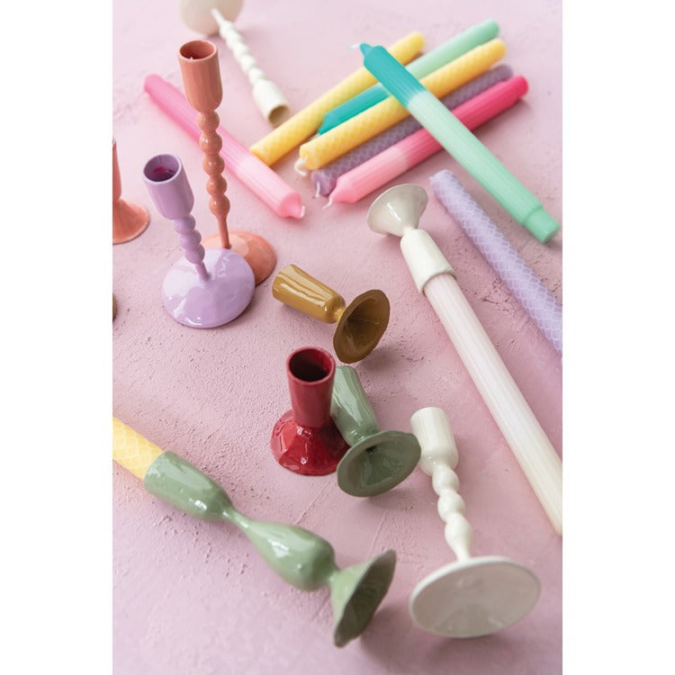 taper holders and candles scattered about