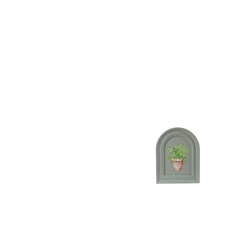 sage green, arched frame with design of a potted plant painted on it