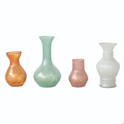orange vase next to a mint vase, next to a pink vase, next to a white vase