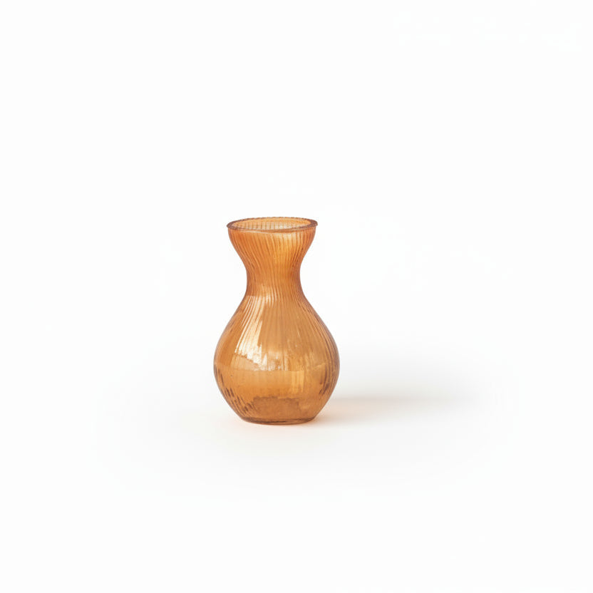 small amber colored vase on white background