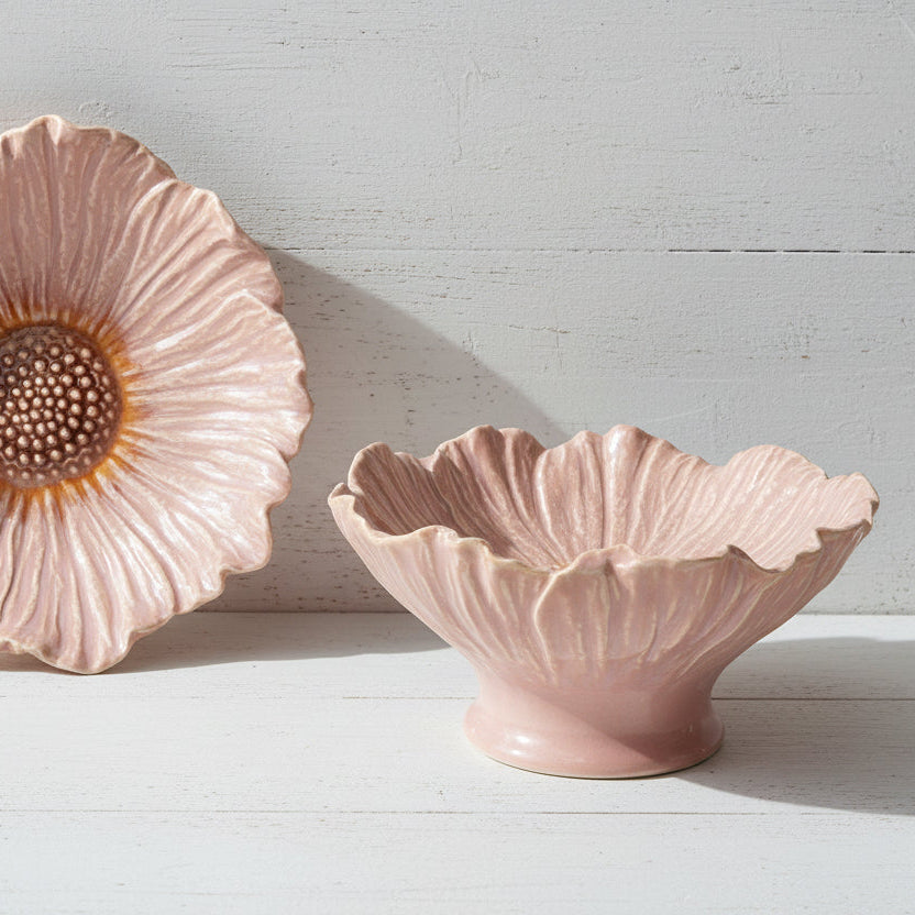 top and side views of pink pedestaled flower shaped bowls next to each other shown on a white wooden background