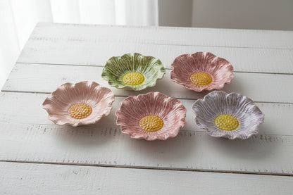 assorted flower shaped bowls on a white wooden table