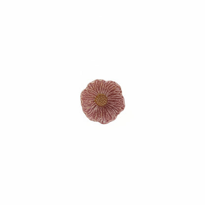 dark pink flower shaped bowl with orange center