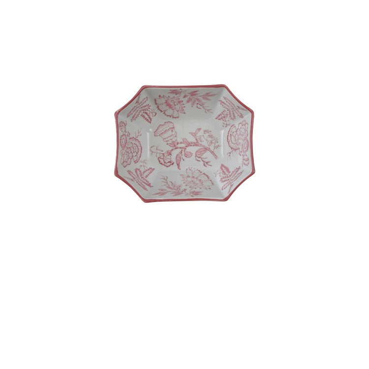 top view of white ceramic bowl with elongated hexagon shape and pink floral design