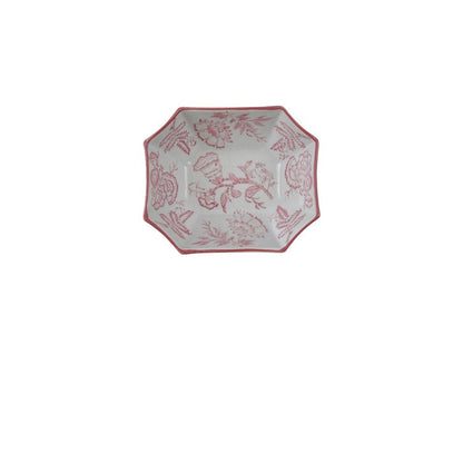top view of white ceramic bowl with elongated hexagon shape and pink floral design