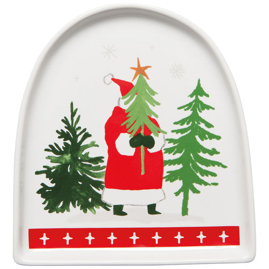 A white stoneware dish with a red and green Christmas design featuring Santa Claus carrying a Christmas tree, along with two other trees and festive decorations.