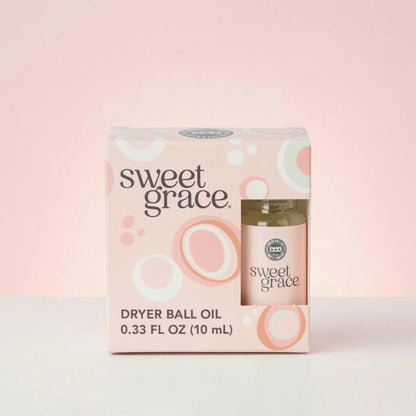 Sweet Grace dryer ball oil packaging on a pink background