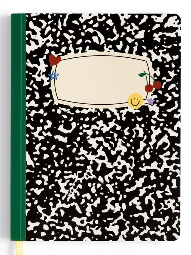 Notebook with black and white abstract pattern and colorful design on the cover and green binding