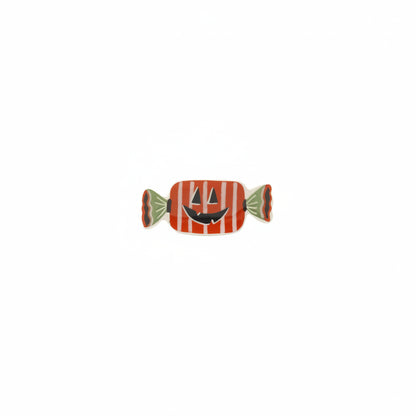 orange and green candy shaped small dish with jack-o-lantern design on it