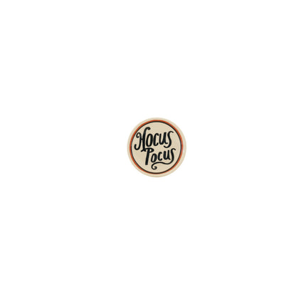 round white trinket tray with "hocus pocus" printed on it in black shown on a white background