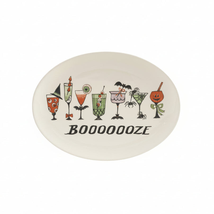 cream colored stoneware tray with halloween themed cocktails in hues of green, orange, purple and black