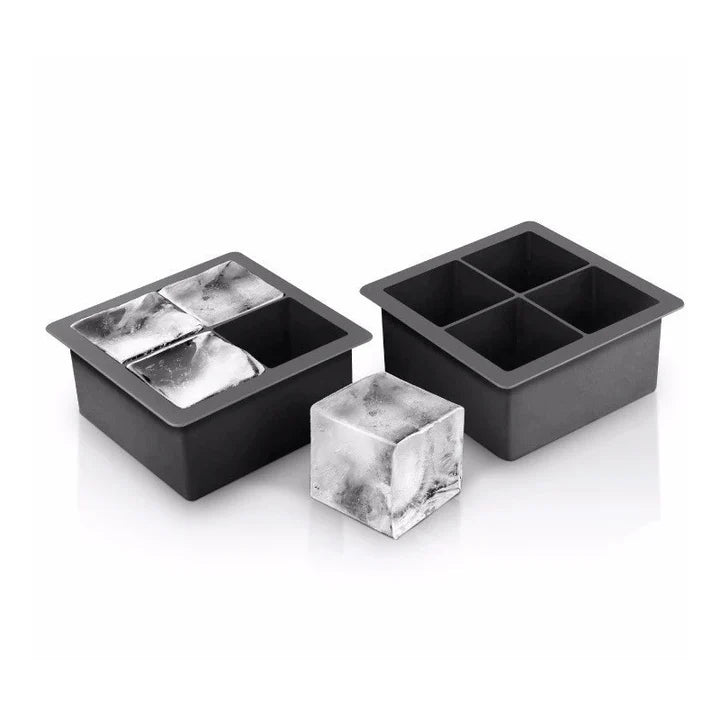 2 black silicone ice trays, one filled with ice and an ice cube set next to it.