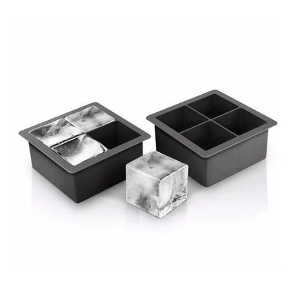 2 black silicone ice trays, one filled with ice and an ice cube set next to it.