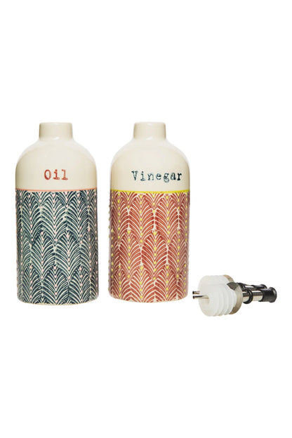 Two ceramic bottles labeled 'Oil' and 'Vinegar' with stoppers set next to them
