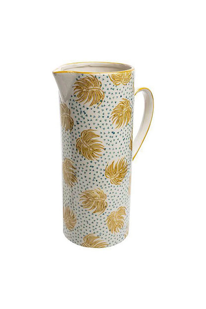 Decorative pitcher with yellow leaf pattern on a white background
