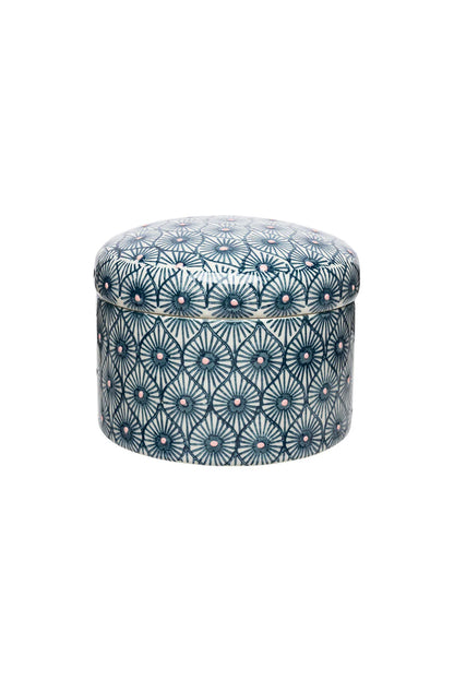 Round canister with a blue and white pattern on a white background