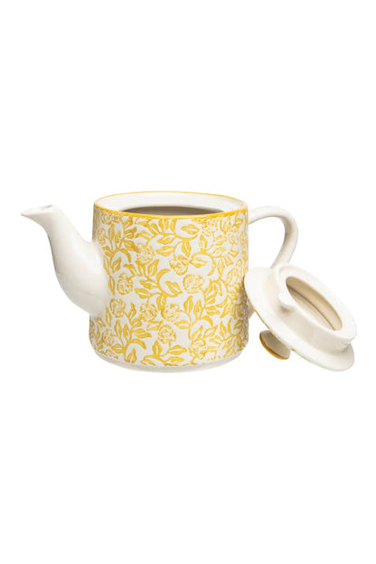 Ceramic teapot with yellow floral pattern with lid set next to it on a white background
