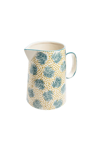 Ceramic pitcher with blue  leaf pattern on a white background