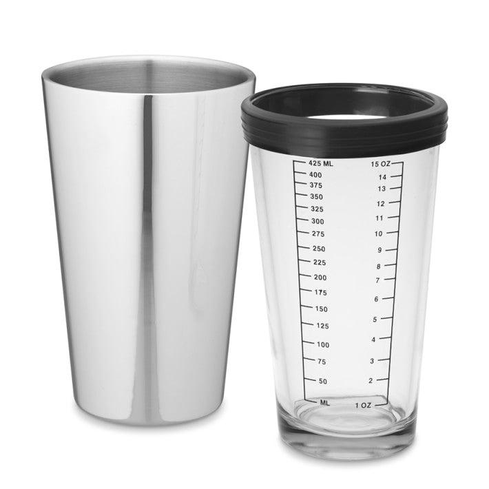 stainless steel shaker set next to glass with silicone rim and measurement markings.