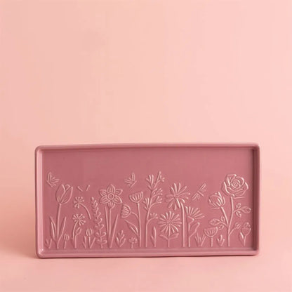 Pink tray with floral embossing on a pink background