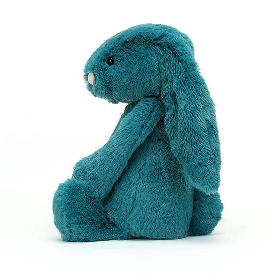 side view of Bashful Teal Bunny Plush Toy sitting on a white background