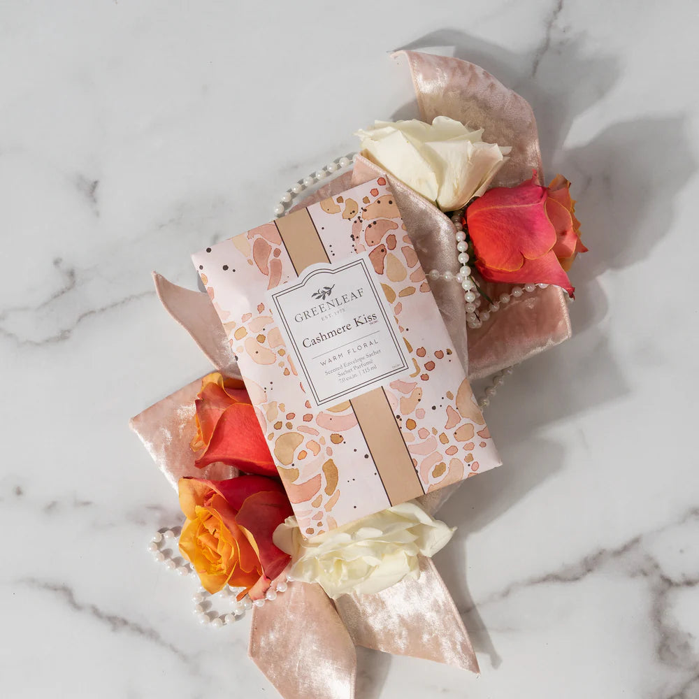Cashmere Kiss Large Sachet arranged with flowers and ribbon on a marble surface